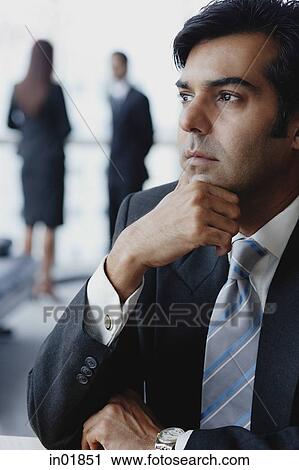 Businessman looking away, hand on chin View Large Photo Image Stock Image - Businessman looking away, hand on chin. Fotosearch