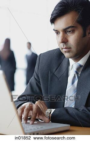 Stock Image - Businessman using laptop. Fotosearch