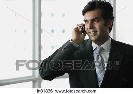 Businessman using mobile phone View Large Photo Image Stock Photograph - Businessman using mobile phone. Fotosearch