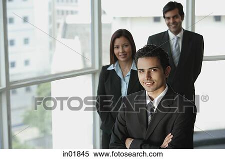 Stock Photography - Businesspeople looking at camera, smiling. Fotosearch