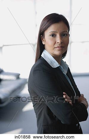 Businesswoman looking at camera, arms crossed View Large Photo Image Stock Photo - Businesswoman looking at camera, arms crossed. Fotosearch