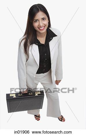 Stock Photograph - Businesswoman looking at camera, carrying briefcase. Fotosearch