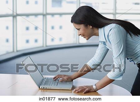 Stock Photo - Businesswoman using laptop. Fotosearch