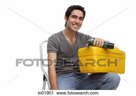 Man with toolbox and drill, sitting on ladder View Large Photo Image Stock Image - Man with toolbox and drill, sitting on ladder. Fotosearch