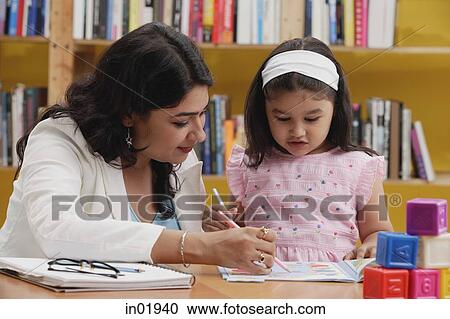 Woman and girl studying in library View Large Photo Image Stock Image - Woman and girl studying in library. Fotosearch
