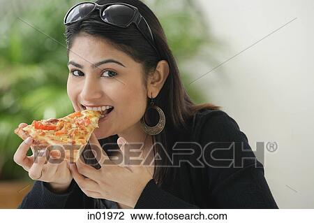Woman eating a slice of pizza View Large Photo Image Stock Image - Woman eating a slice of pizza. Fotosearch