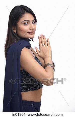 Woman in traditional Indian clothing, hands together, turning to look at camera View Large Photo Image Stock Image - Woman in traditional Indian clothing, hands together, turning to look at camera. Fotosearch