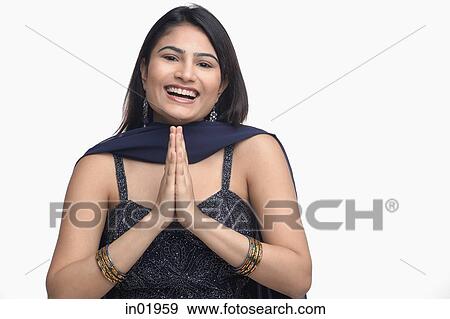 Stock Photo - Woman in traditional Indian clothing, hands together, smiling. Fotosearch