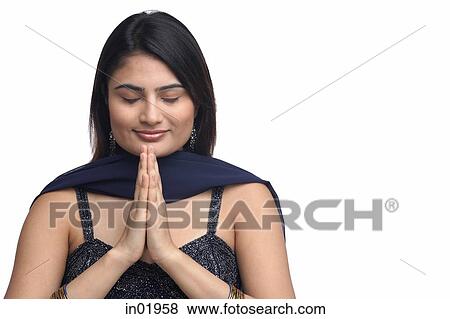 Stock Photo - Woman with hands together, eyes closed. Fotosearch