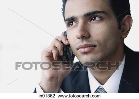 Young businessman using mobile phone, head shot View Large Photo Image Stock Image - Young businessman using mobile phone, head shot. Fotosearch
