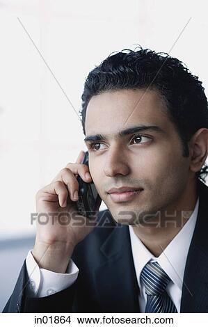 Young businessman with mobile phone, head shot View Large Photo Image Picture - Young businessman with mobile phone, head shot. Fotosearch