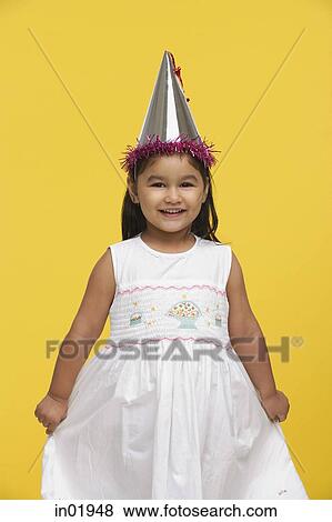Young girl in white dress and party hat View Large Photo Image Stock Photo - Young girl in white dress and party hat. Fotosearch