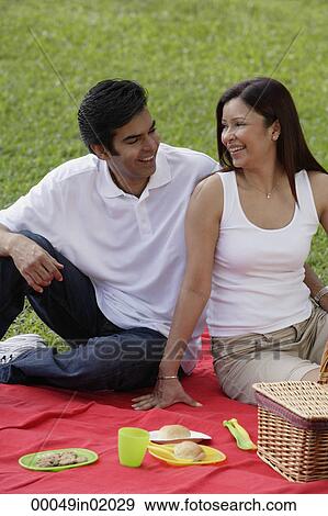 A couple have a picnic together in the park View Large Photo Image Stock Photo - A couple have a picnic together in the park. Fotosearch