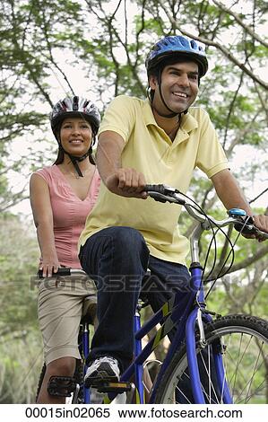 A couple ride a bike together View Large Photo Image Stock Photography - A couple ride a bike together. Fotosearch