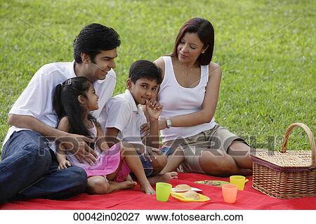 A family have a picnic together in the park View Large Photo Image Stock Photo - A family have a picnic together in the park. Fotosearch