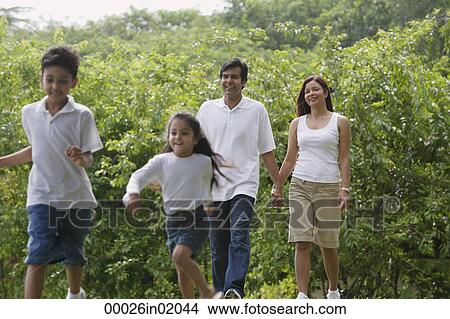 A family walk together in the park View Large Photo Image Picture - A family walk together in the park. Fotosearch
