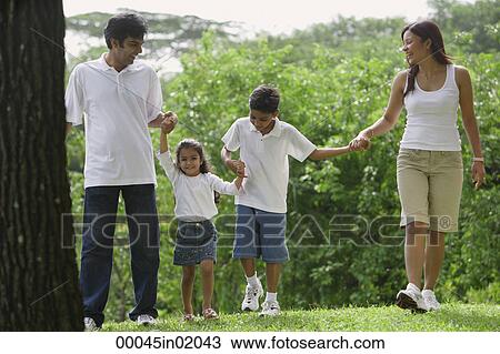 A family walk together in the park View Large Photo Image Stock Image - A family walk together in the park. Fotosearch