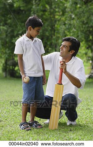 A father and son play cricket together View Large Photo Image Stock Image - A father and son play cricket together. Fotosearch