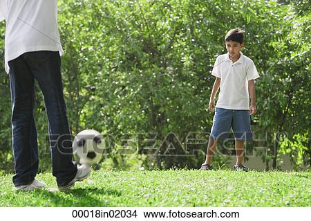A father and son play soccer together View Large Photo Image Picture - A father and son play soccer together. Fotosearch