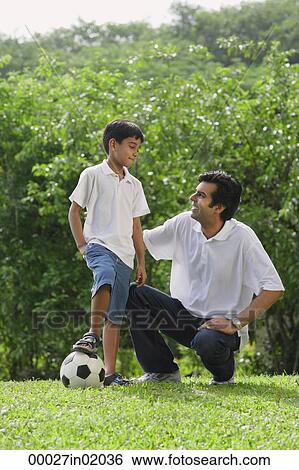 A father and son play soccer together View Large Photo Image Stock Photograph - A father and son play soccer together. Fotosearch