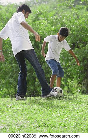 A father and son play soccer together View Large Photo Image Stock Photography - A father and son play soccer together. Fotosearch
