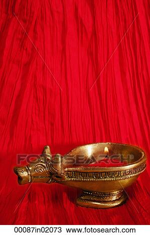 Stock Image - A golden ox candle holder and candle. Fotosearch