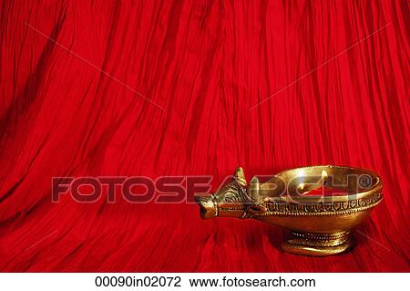 Stock Image - A golden ox candle holder and candle. Fotosearch