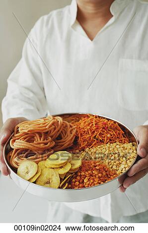 A man holds a chips platter View Large Photo Image Picture - A man holds a chips platter. Fotosearch