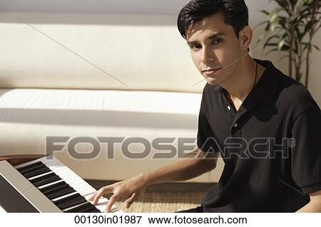 A man plays the piano View Large Photo Image Stock Photo - A man plays the piano. Fotosearch