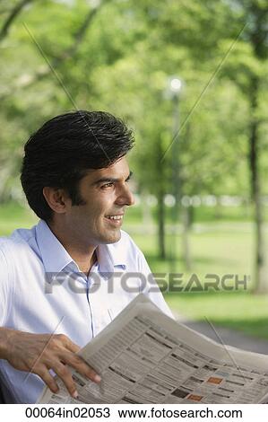 A man reads the newspaper in the park View Large Photo Image Stock Image - A man reads the newspaper in the park. Fotosearch