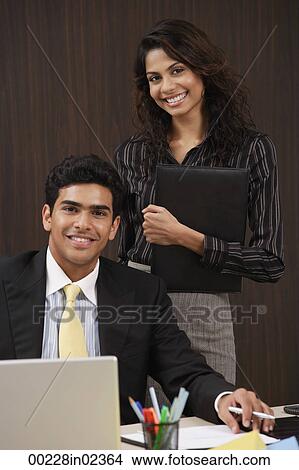 Businessman and woman smiling at camera View Large Photo Image Picture - Businessman and woman smiling at camera. Fotosearch