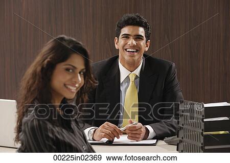 Businessman and woman smiling at camera View Large Photo Image Stock Photo - Businessman and woman smiling at camera. Fotosearch