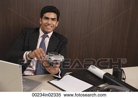 Businessman playing with toy car View Large Photo Image Stock Photography - Businessman playing with toy car. Fotosearch