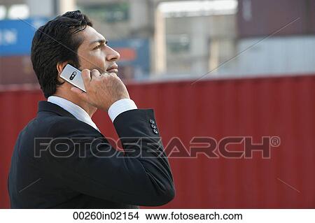 Businessman talking on mobile phone View Large Photo Image Picture - Businessman talking on mobile phone. Fotosearch
