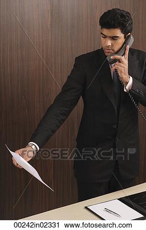 Businessman talking on the phone View Large Photo Image Stock Image - Businessman talking on the phone. Fotosearch