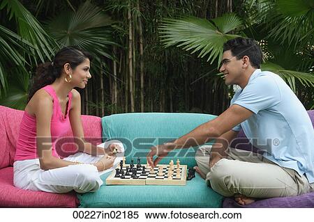 Couple playing chess outdoors View Large Photo Image Stock Photography - Couple playing chess outdoors. Fotosearch