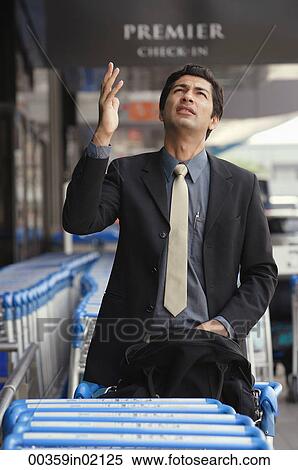 Man gesturing and looking up View Large Photo Image Stock Photography - Man gesturing and looking up. Fotosearch