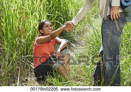 Man helping woman stand up View Large Photo Image Stock Photograph - Man helping woman stand up. Fotosearch