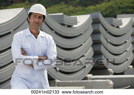 Man in work uniform arms crossed, looking at camera View Large Photo Image Stock Image - Man in work uniform arms crossed, looking at camera. Fotosearch
