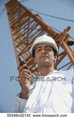 Man in work uniform looking down View Large Photo Image Stock Image - Man in work uniform looking down. Fotosearch