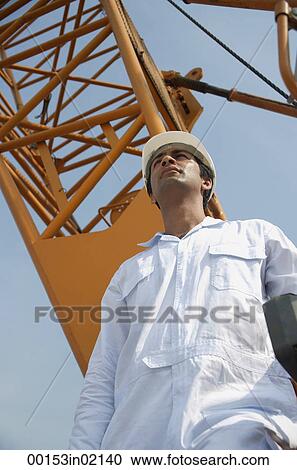 Man in work uniform looking into distance View Large Photo Image Stock Image - Man in work uniform looking into distance. Fotosearch