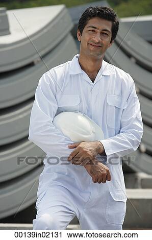 Man in work uniform, smiling at camera View Large Photo Image Stock Image - Man in work uniform, smiling at camera. Fotosearch