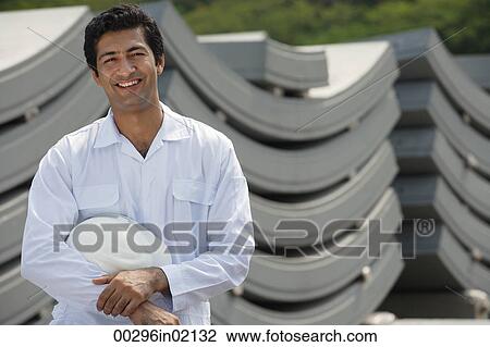 Man in work uniform, smiling at camera View Large Photo Image Stock Image - Man in work uniform, smiling at camera. Fotosearch