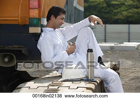 Man in work uniform taking a break View Large Photo Image Stock Photo - Man in work uniform taking a break. Fotosearch