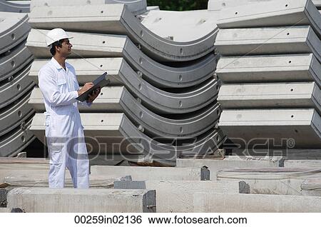 Man in work uniform writing on clipboard View Large Photo Image Stock Photograph - Man in work uniform writing on clipboard. Fotosearch