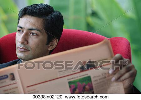 Stock Image - Man reading financial newspaper. Fotosearch