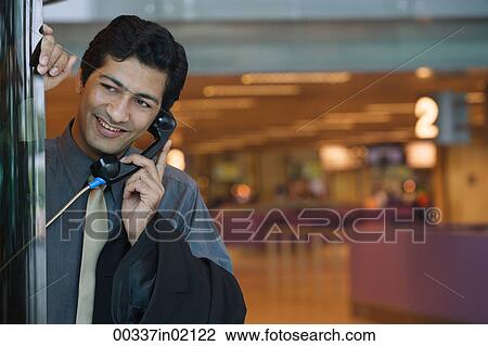Man talking on pay phone View Large Photo Image Stock Image - Man talking on pay phone. Fotosearch