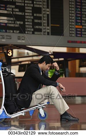 Man waiting in departure lounge at airport View Large Photo Image Stock Photo - Man waiting in departure lounge at airport. Fotosearch