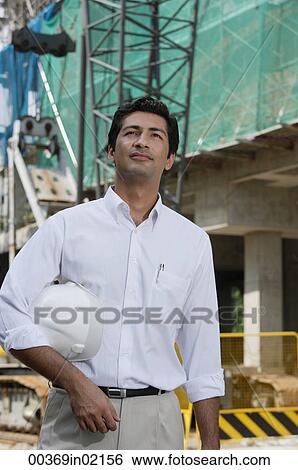 Man with helmet, looking into distance View Large Photo Image Stock Photograph - Man with helmet, looking into distance. Fotosearch