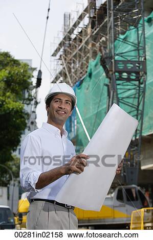 Man with plans, smiling into distance View Large Photo Image Stock Photo - Man with plans, smiling into distance. Fotosearch